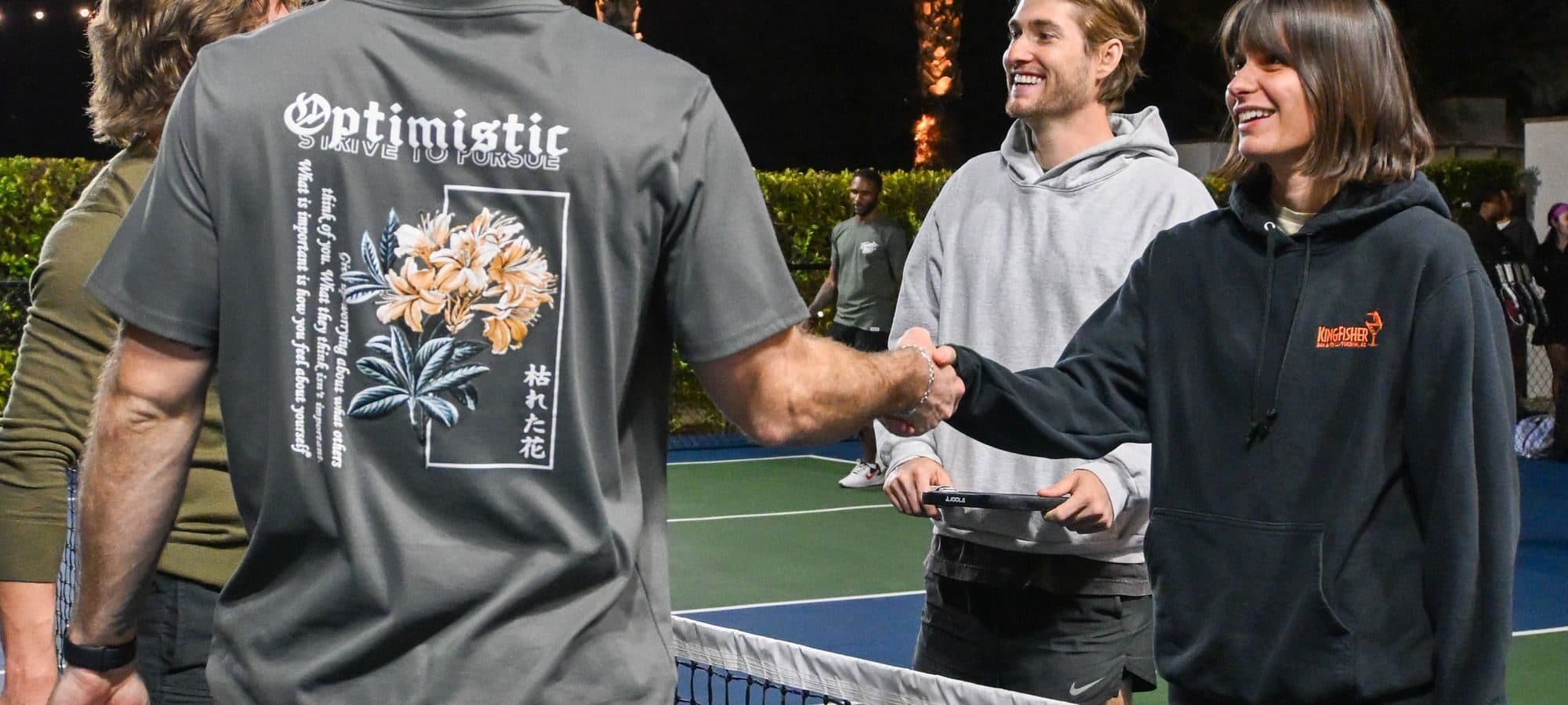 Pickleball players greeting each other at the net